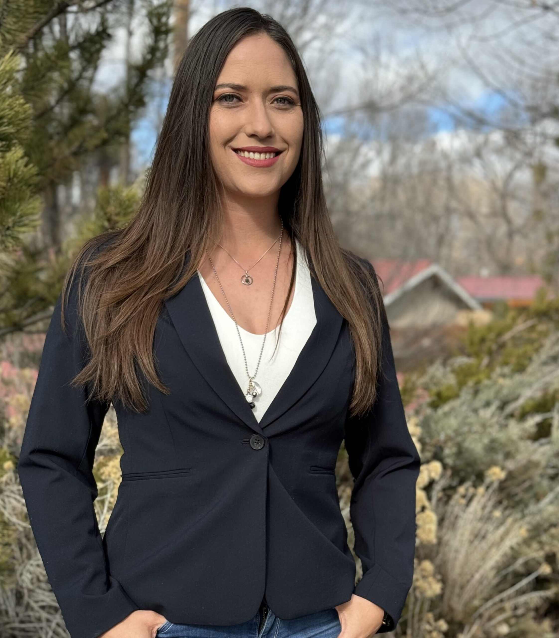 A woman with long hair and brown shirt